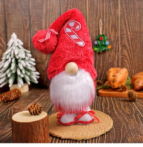 Close-up of a Christmas gnome doll with a plush red hat and candy cane embroidery details