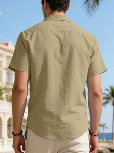 Rear view of khaki short-sleeve polo shirt showing cotton-linen texture and holiday vibe