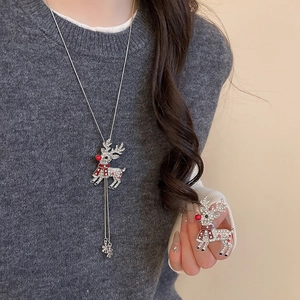Detail of Christmas reindeer necklace and brooch set with sparkling rhinestones and tassels