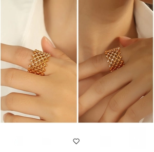 Detail of wide gold honeycomb ring with white rhinestones on model's finger