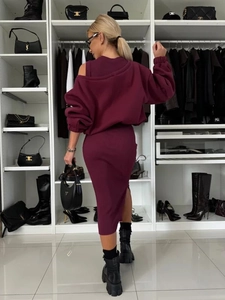 Detail of wine red knit two-piece set featuring off-shoulder top and slit midi skirt