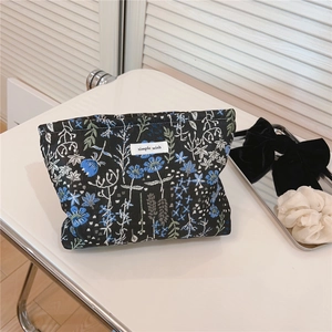 Close-up of floral canvas cosmetic bag with simple wish label and zip closure