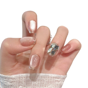 Pink cat eye press-on nails with luxury champagne rhinestones in a square shape