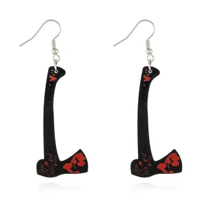 Detailed shot of axe-shaped acrylic earrings with realistic red blood splatters for Halloween