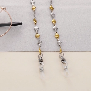 Close-up of gold and silver heart-shaped eyeglass chain with lobster clasps and silicone loops