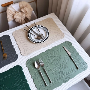 Embossed faux leather placemats set in beige, grey and green with Nordic patterns