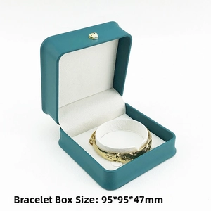 Detail view of 95x95x47mm dark teal PU leather bracelet box with a golden crown lock
