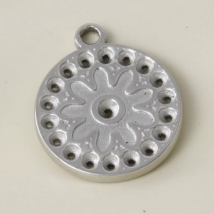 Macro view of 304 stainless steel round pendant with an eight-petal flower engraving