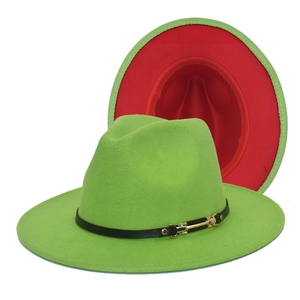 Detail of green wool fedora with red underside brim and black leather buckle band
