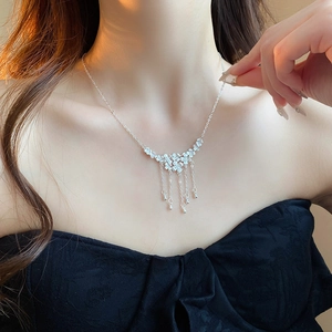 Elegant silver flower tassel necklace for women featuring fine chain fringe and metallic beads