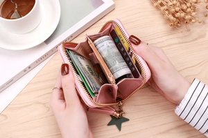 Detailed interior of pink zipper coin purse with card slots and star tassel accessory