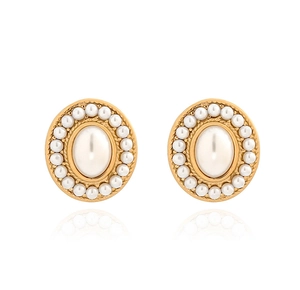 Close-up of elegant gold-plated oval pearl earrings with reflections on a white background