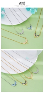 Detailed view of angel wing necklaces with blue and white crystals in gold and silver
