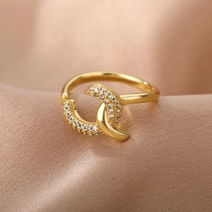 Macro shot of gold adjustable double ring with pavé crystals on champagne silk