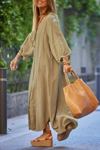 Detail of olive green cotton linen maxi dress featuring stylish puff sleeves and side slit
