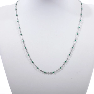 Detail of silver stainless steel bead chain necklace with green enamel dots on mannequin