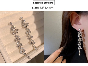Detail of silver long tassel earrings with marquise stones, size 7.1x1.4cm on model