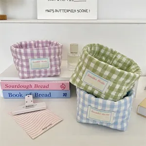 Quilted checkered soft storage baskets in pastel colors for desktop organization