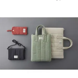 Quilted cotton padded bags in various colors with textured vertical stripes and minimalist labels