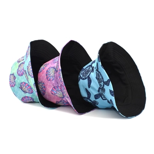 Three reversible bucket hats with ocean animal prints like sea turtles and shells