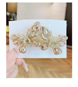 Detail of butterfly hair clip with champagne crystals and gold-plated spring clamp