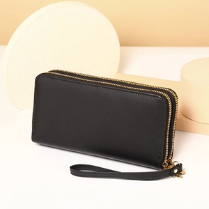 Detail view of the black long PU leather clutch wallet with dual gold zippers and wristlet