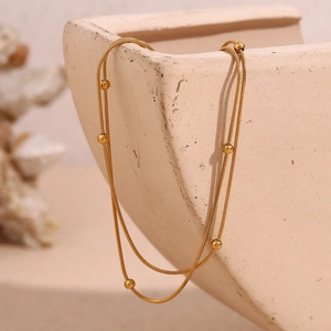 Close-up of double-layer 18K gold plated snake chain with small round beads detail