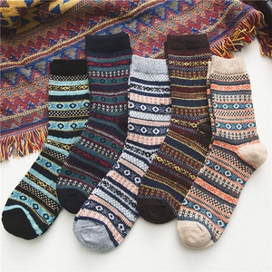 Close-up of five pairs of thick wool blend crew socks with vintage ethnic patterns
