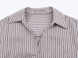 Close-up of the grey striped shirt neckline with a lapel collar and V-neckline detail