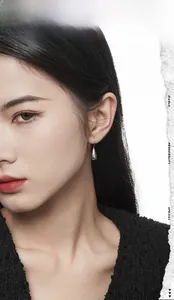 Close-up of polished S925 sterling silver water drop earrings on a model ear