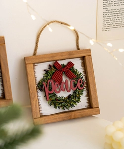 Detail of wooden Peace sign plaque with miniature wreath and red checkered bow decoration