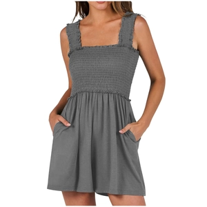 Detail of dark grey romper showing smocked bodice and soft knit fabric texture