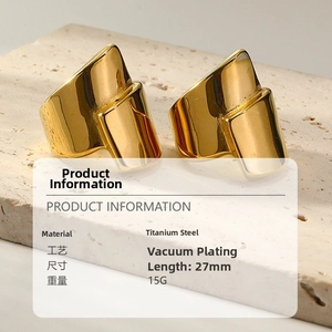 Detailed view of wide 18k gold plated titanium steel rings on textured stone