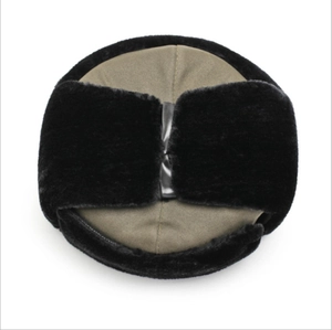 Detail of winter trapper hat with grey-green ripstop fabric and black faux fur earflaps