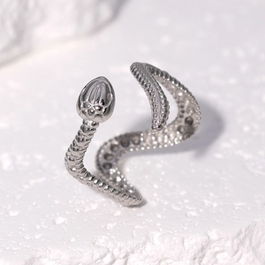 Macro shot of silver stainless steel snake ring with detailed scale texture and open band