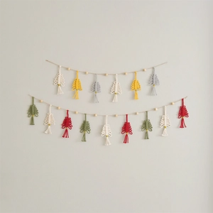 Detail of handmade macrame Christmas tree garland with wooden beads on a white wall
