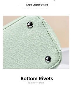 Detailed close-up of mint green litchi texture leather bag base with silver rivets