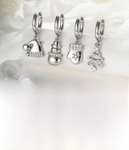 Detailed view of silver snowman and Christmas tree charms on zircon hoop earrings