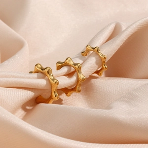 Three-piece gold plated stainless steel rivet ear cuffs set on elegant champagne satin fabric