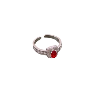 Adjustable silver ring featuring an oval red gemstone surrounded by sparkling zircon