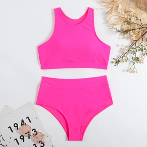 Detail view of neon pink two-piece swimsuit with high-waist bikini bottoms and tank top