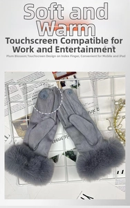 Detail of grey winter gloves featuring furry cuffs and touch-screen floral embroidery