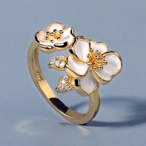 Detail of white enamel camellia flowers on gold ring with S925 sterling silver hallmark