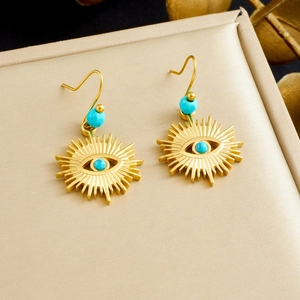 Bohemian gold sunburst earrings with turquoise beads and evil eye charm in a gift box