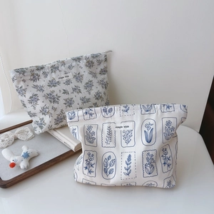 Detail of floral printed cotton makeup bags with simple wish label and zip closure