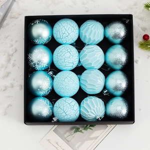 Detailed view of 16 ice blue Christmas ornaments with diverse textures in a gift box