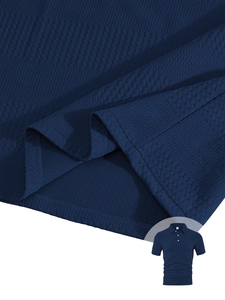 Close-up of navy blue men's Polo shirt showing waffle texture and honeycomb fabric detail