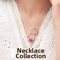 Close-up of multi-layer silver necklace with pink heart charms and gold key pendants