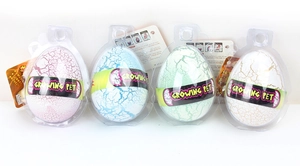 Detailed view of four colorful Growing Pet dinosaur eggs in blister pack packaging