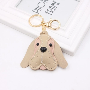 Detail of beagle dog leather keychain with lychee texture and gold lobster clasp